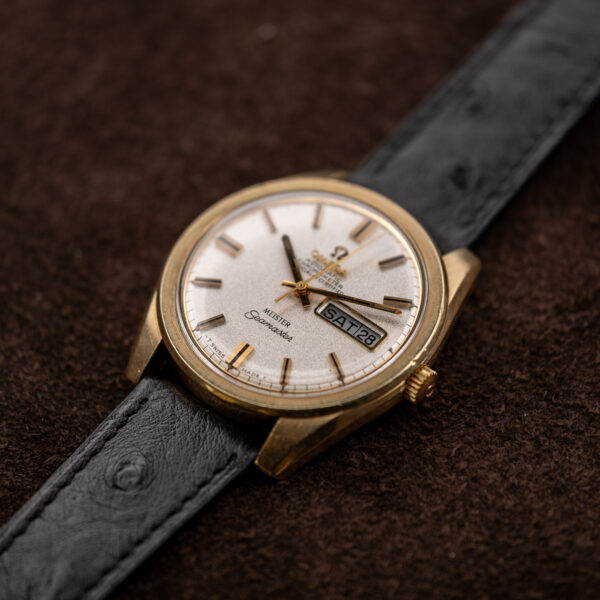 Omega Seamaster low crown-side view showing raised crystal edge, textured bezel and black strap attachment