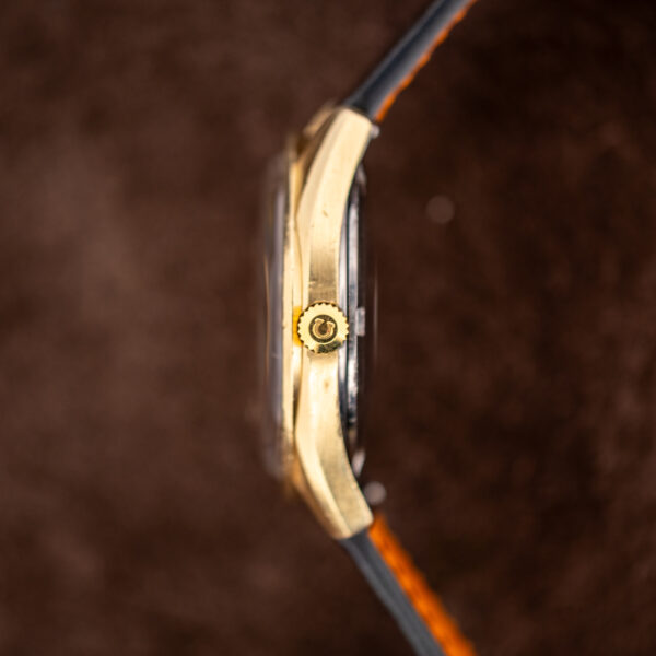 Omega Seamaster 168.023 crown-side profile with signed winding crown and curved case beside black strap