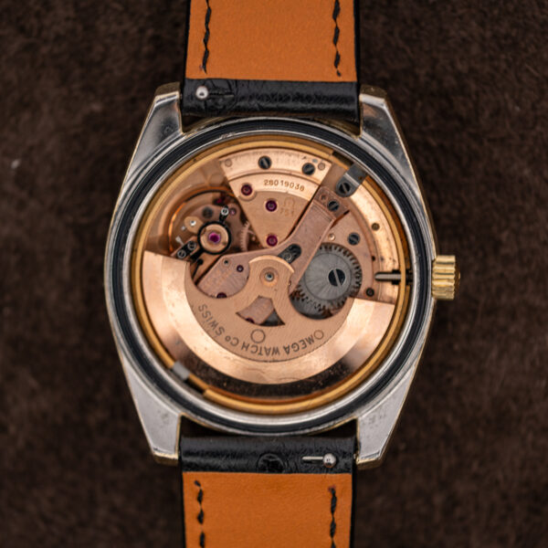 Omega 751 automatic movement inside opened Seamaster case, with signed rotor, bridges and winding gears visible