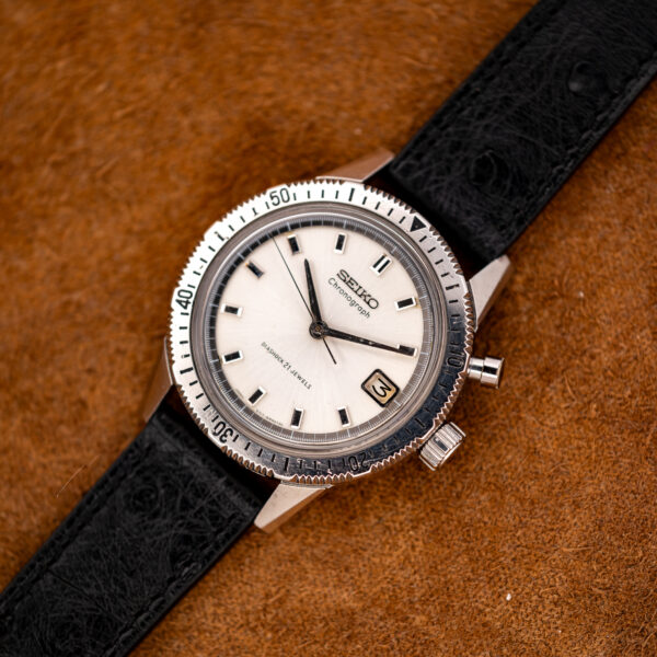 Seiko 5717-8990 chronograph from the opposite angle, with numbered steel timing bezel and textured black ostrich strap