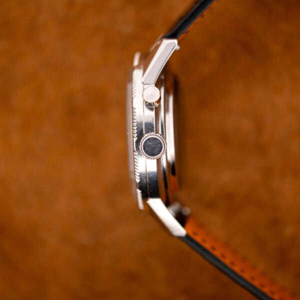 Profile of the Seiko 5717-8990 case from the crown side, with the single pusher and toothed rotating bezel