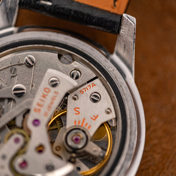 Close-up of the Seiko caliber 5717A movement stamp next to the regulator and balance wheel