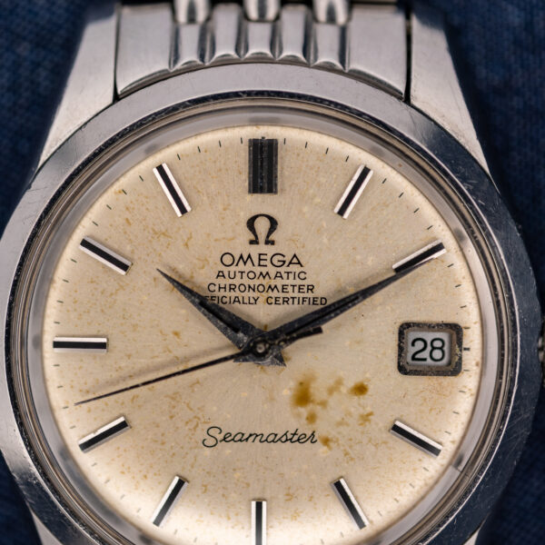 Omega Seamaster chronometer dial close-up showing certification wording, pointed hands and the framed date display