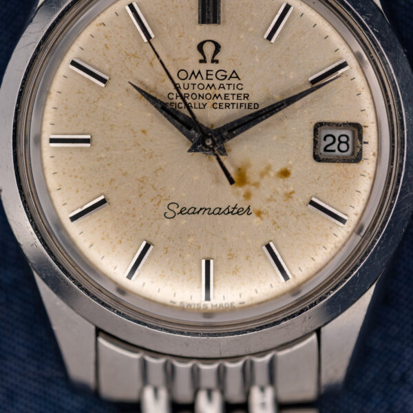 Omega Seamaster lower dial detail showing script signature, minute track and applied baton hour markers