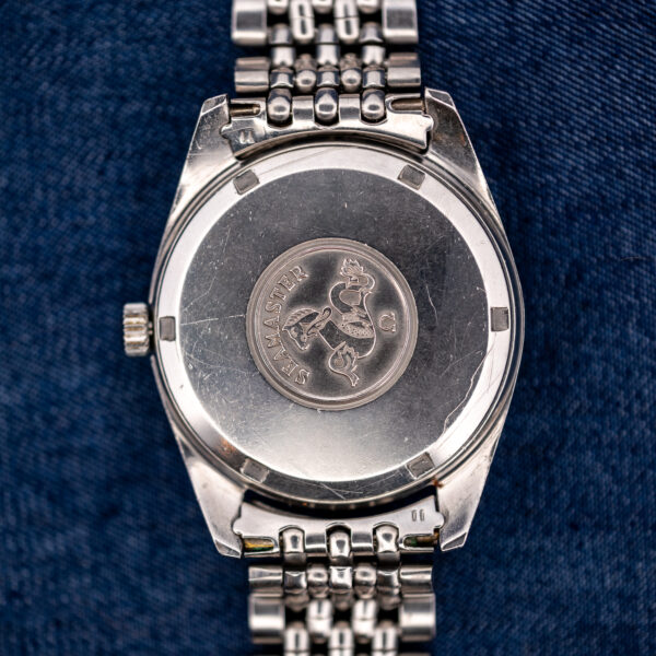Omega Seamaster outer caseback with hippocampus emblem and bracelet end links surrounding the opening notches