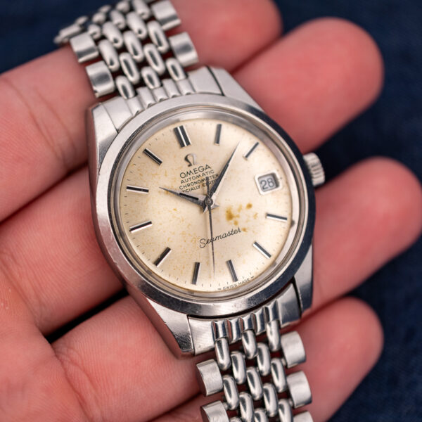 Omega Seamaster hand-held frontal view showing chronometer lettering, date aperture and applied baton markers