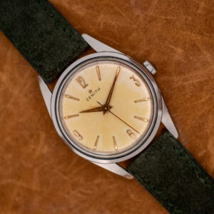 Zenith manual wind watch diagonal portrait with Arabic quarter-hour numerals and forest green Italian suede strap
