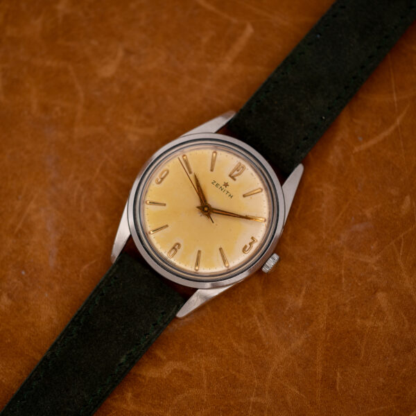 Zenith manual wind watch wide diagonal arrangement with no-date dial and forest green suede strap
