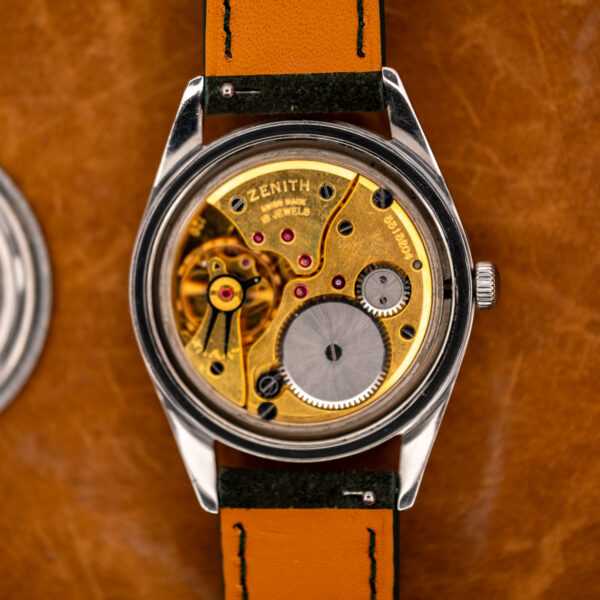 Zenith manual wind movement inside opened case, showing signed bridge, winding gears and visible balance assembly
