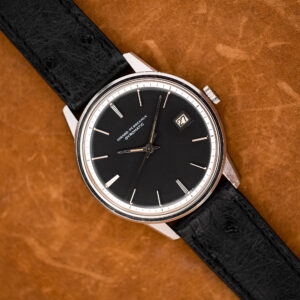 Girard Perregaux Gyromatic overhead view with black dial, white minute ring and textured black strap