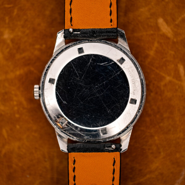Girard Perregaux Gyromatic underside showing notched caseback and stitched lining of the attached strap