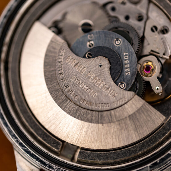 Girard Perregaux Gyromatic rotor close-up showing engraved maker lettering, jewel inscription and adjacent balance