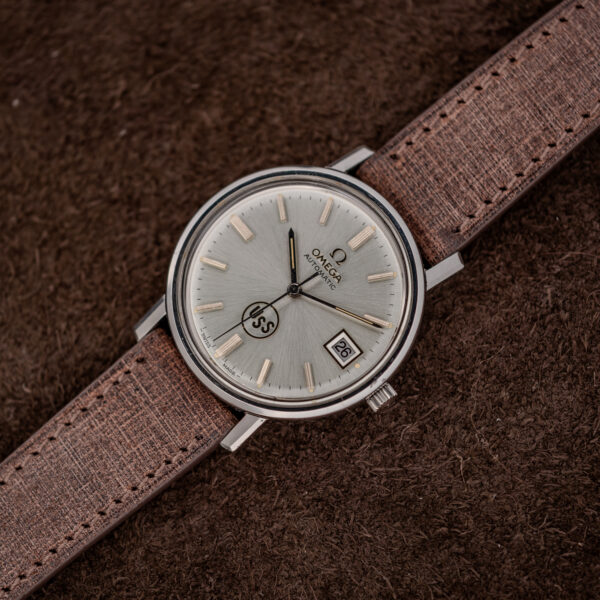 Omega automatic low diagonal view highlighting sunburst dial, applied baton indices and the framed date window