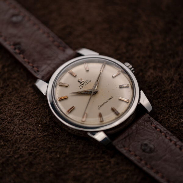 Omega Seamaster low diagonal view with applied markers, pointed hands and stitched choco brown strap