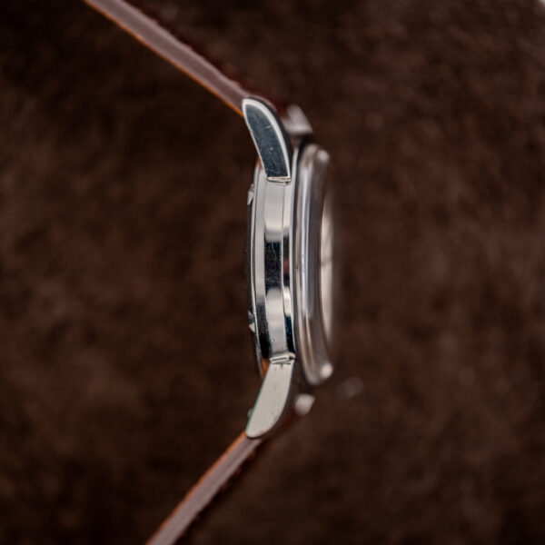 Omega Seamaster opposite side view emphasizing curved lugs, polished case flank and domed crystal silhouette