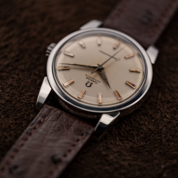 Omega Seamaster low inverted view showing upper dial lettering, raised crystal and the broad case lugs