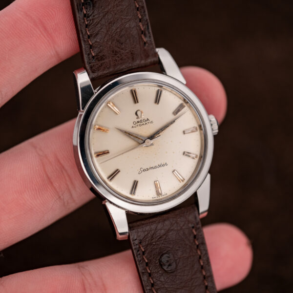 Omega Seamaster 14761 held in hand, showing no-date dial and the stitched ostrich strap