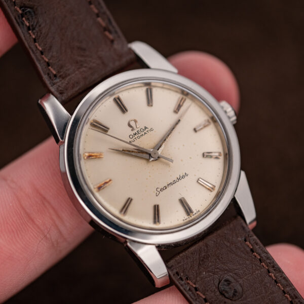 Omega Seamaster hand-held angle highlighting pointed hands, applied hour markers and broad stainless steel lugs