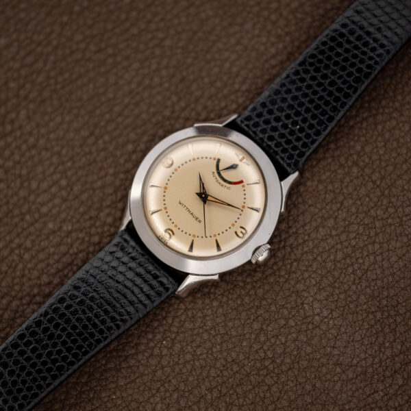 Wittnauer 2092 and black leather strap arranged diagonally with power reserve display above the hands