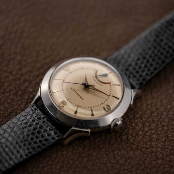 Wittnauer 2092 low angled view showing raised crystal, reserve scale and textured strap attachment
