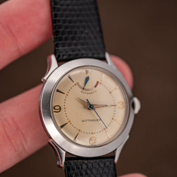 Wittnauer 2092 handheld angled view with applied numerals, upper reserve pointer and textured strap