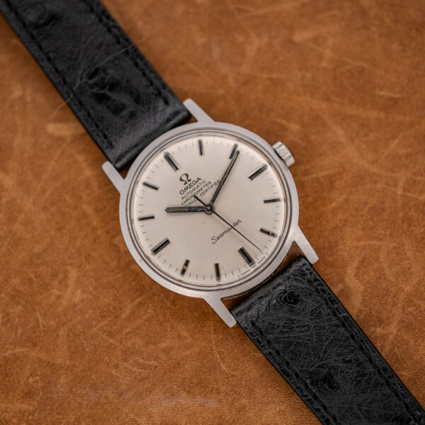 Wide front view of the Omega Seamaster 167.070 showing silver dial, black-centered batons and strap