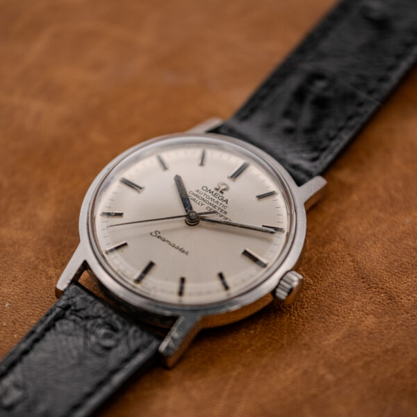 Low crown-side view of the Omega Seamaster chronometer dial, crown and domed crystal