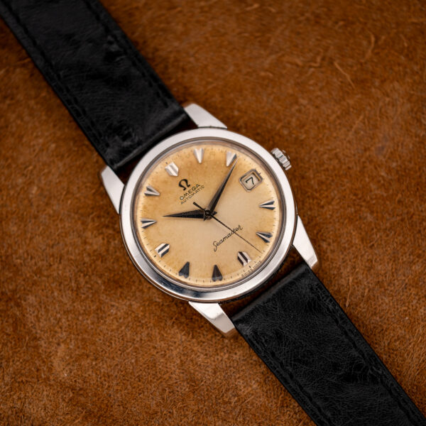 Opposite diagonal view of the Omega 166.009 showing the framed date window and faceted hour markers
