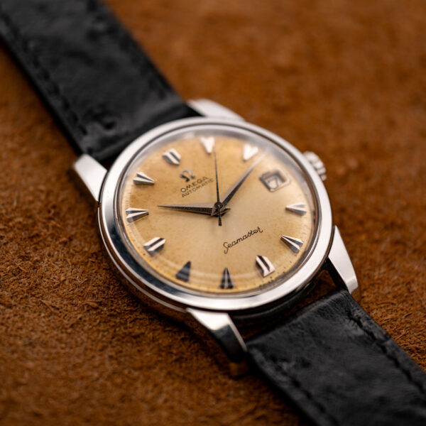 Low oblique view of the Omega Seamaster 166.009 amber tropical dial and faceted silver hour markers