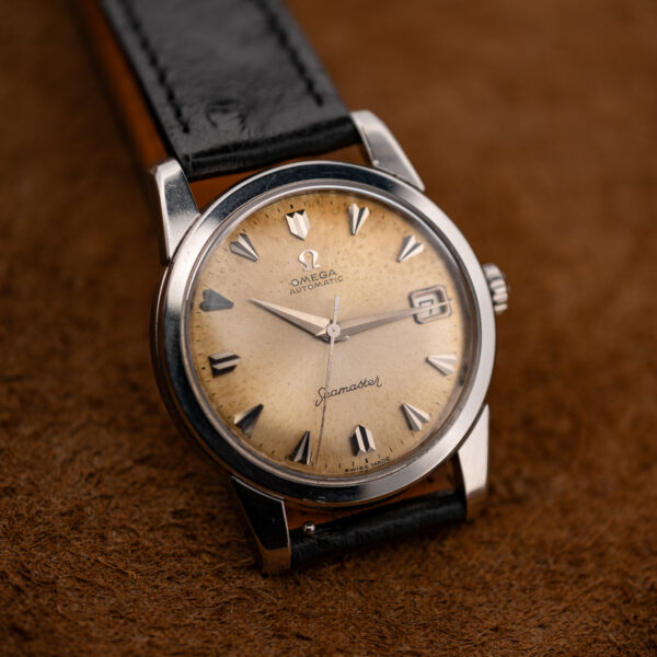 Upright oblique view of the Omega 166.009 dial with faceted hour markers and framed date window