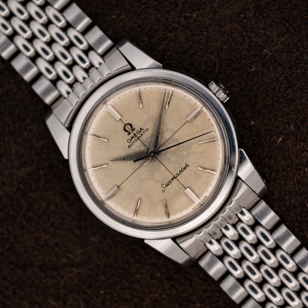 1961 Omega Seamaster 14761 with off-white crosshair dial on a silver-tone steel bracelet, angled front view