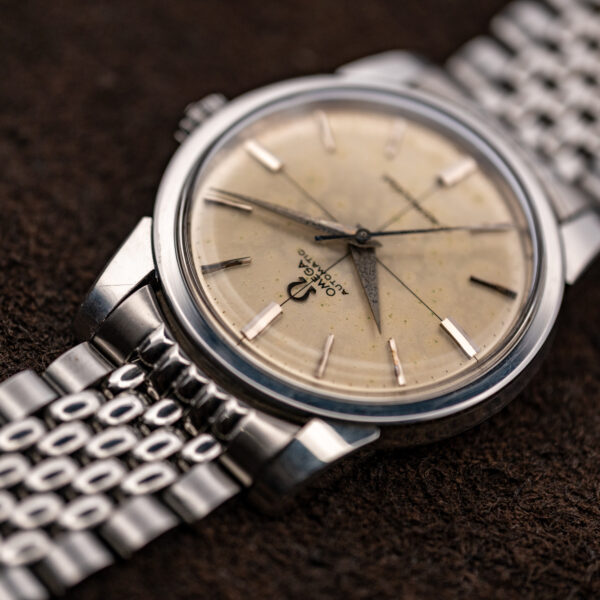 Inverted low angle on the 1961 Omega Seamaster showing the dial, crystal edge and bracelet end link