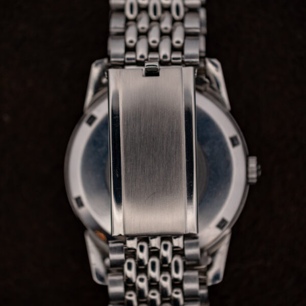 Underside of the Omega Seamaster steel bracelet with the plain brushed folding clasp closed