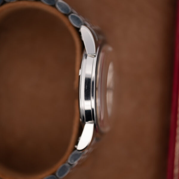 Opposite case profile of the 1961 Omega Seamaster showing curved lugs and the raised crystal