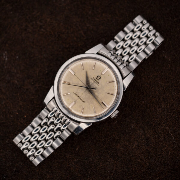 Full view of the 1961 Omega Seamaster 14761 with off-white crosshair dial and silver-tone bracelet