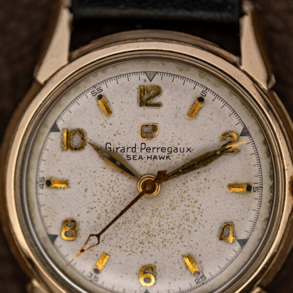 Girard Perregaux Sea Hawk B-1801 dial close-up with maker signature, applied numerals and speckled patina
