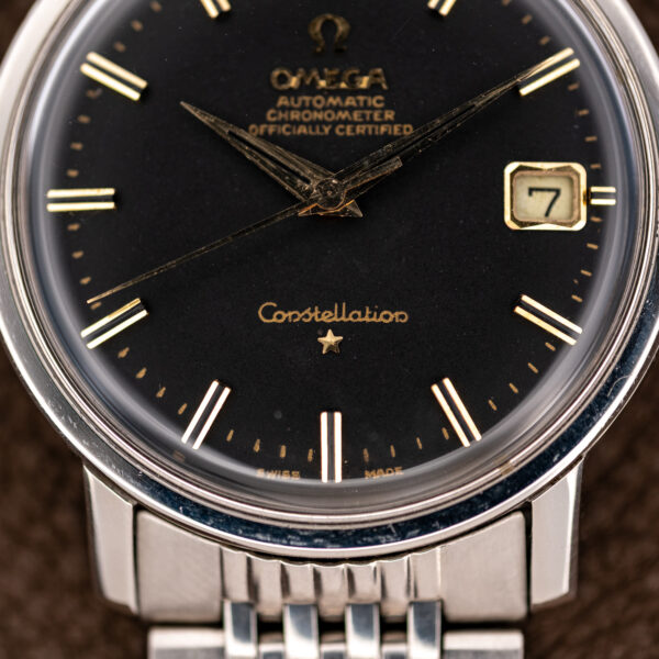 Omega Constellation 168.010 lower dial detail showing applied star, Swiss signature and gold-colored minute track