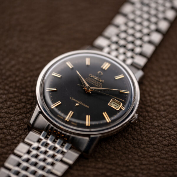 Omega Constellation 168.010 low angled view showing raised crystal, framed date and adjoining bracelet links