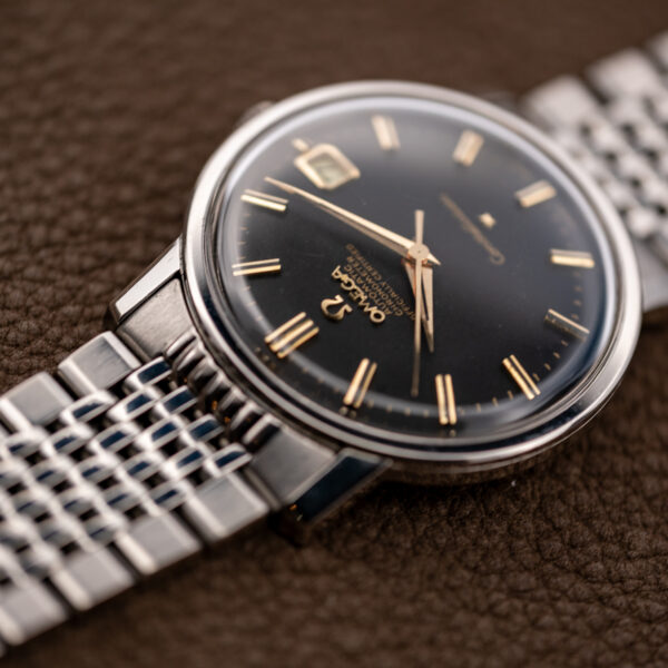 Omega Constellation 168.010 low perspective highlighting crystal curvature and the bracelet connection above the dial