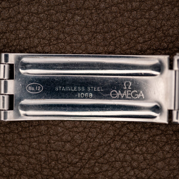 Omega Constellation bracelet clasp interior showing Omega signature, stainless steel lettering and stamped bracelet number