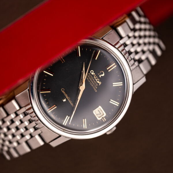Omega Constellation 168.010 angled display view showing black dial, framed date and linked bracelet