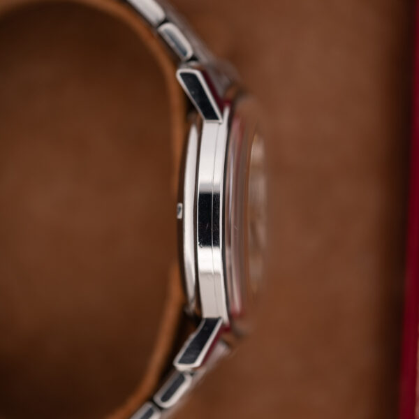 Omega Constellation 168.010 opposite profile revealing smooth case flank and projecting crystal above the bezel