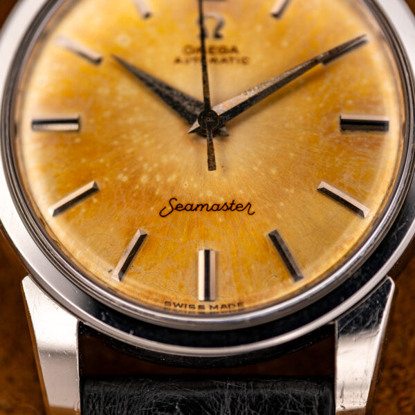 Lower half of the amber Omega Seamaster dial with Seamaster script, Swiss Made line and pale spotting