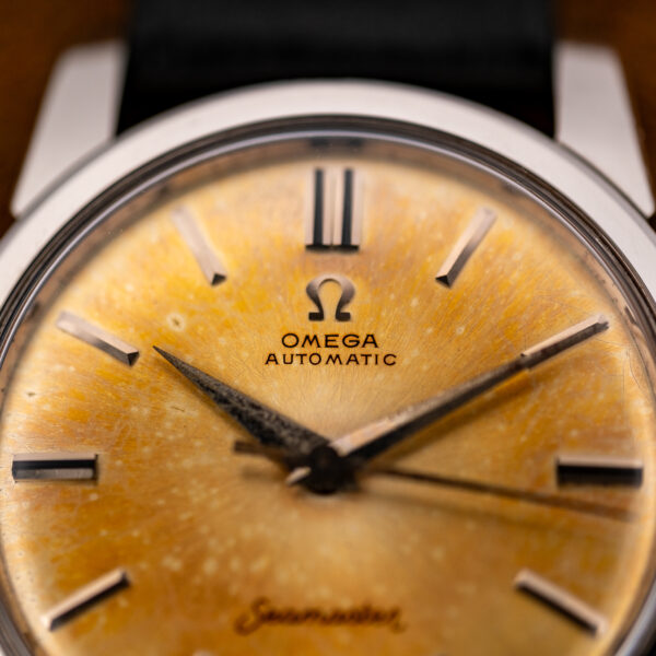 Upper dial close-up of the Omega Seamaster showing the applied Omega symbol, Automatic text and doubled twelve marker