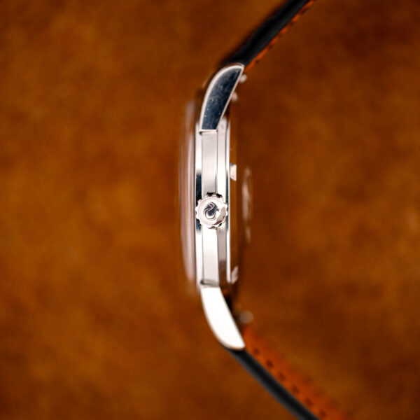 Side profile of the steel Omega Seamaster case with the Omega-signed fluted crown and raised crystal