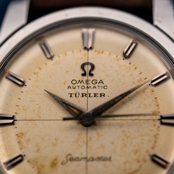 Upper dial close-up of the Omega Seamaster showing Omega, Automatic and Türler lettering along the vertical crosshair