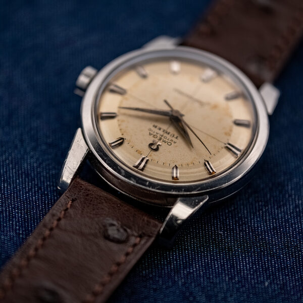 Low view from twelve o'clock of the Omega Türler dial showing the applied logo and faceted markers