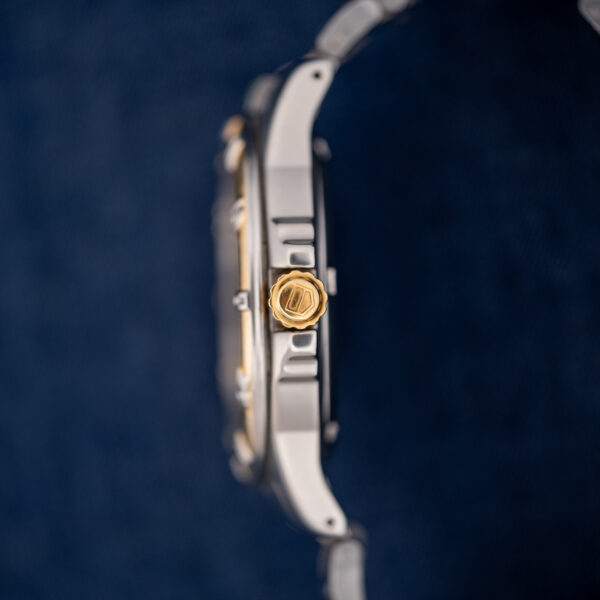 Crown side of the TAG Heuer 995.706 K case in profile, with the gold-tone crown and case flank