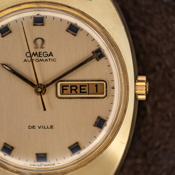 Right side of the Omega De Ville dial with the framed day-date window and gold-framed square hour markers