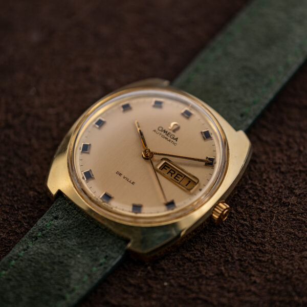Omega 166.053 De Ville seen low from the crown side, champagne dial and square markers catching light